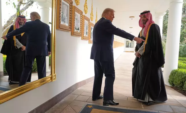 President Donald Trump and Saudi Arabia's Crown Prince Mohammed bin Salman walk along the Colonnade at the White House, Tuesday, Nov. 18, 2025, in Washington. (AP Photo/Evan Vucci)
