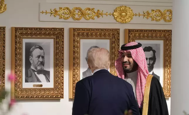 President Donald Trump walks with Saudi Arabia's Crown Prince Mohammed bin Salman along the colonnade, at the White House, Tuesday, Nov. 18, 2025, in Washington. (AP Photo/Alex Brandon)