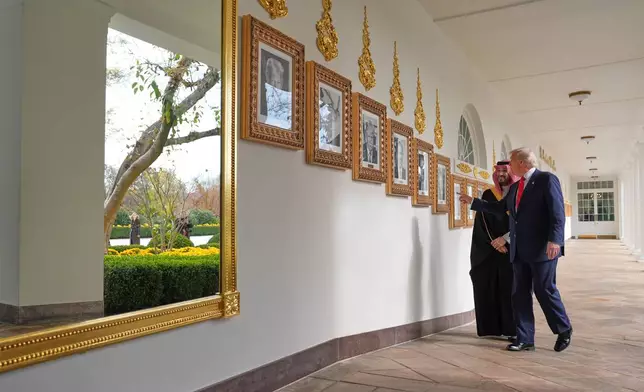 President Donald Trump and Saudi Arabia's Crown Prince Mohammed bin Salman walk along the Colonnade at the White House, Tuesday, Nov. 18, 2025, in Washington. (AP Photo/Evan Vucci)