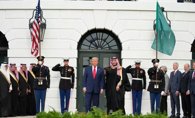 President Donald Trump stands with Saudi Arabia's Crown Prince Mohammed bin Salman on his visit to the White House, Tuesday, Nov. 18, 2025, in Washington. (AP Photo/Mark Schiefelbein)