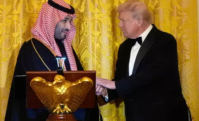President Donald Trump shakes hands with Saudi Arabia's Crown Prince Mohammed bin Salman during a dinner in the East Room of the White House, Tuesday, Nov. 18, 2025, in Washington. (AP Photo/Alex Brandon)
