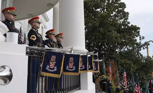 Members of the United States Army Band Herald Trumpets stand ready for President Donald Trump to welcome Saudi Arabia's Crown Prince Mohammed bin Salman to the White House, Tuesday, Nov. 18, 2025, in Washington. (AP Photo/Alex Brandon)