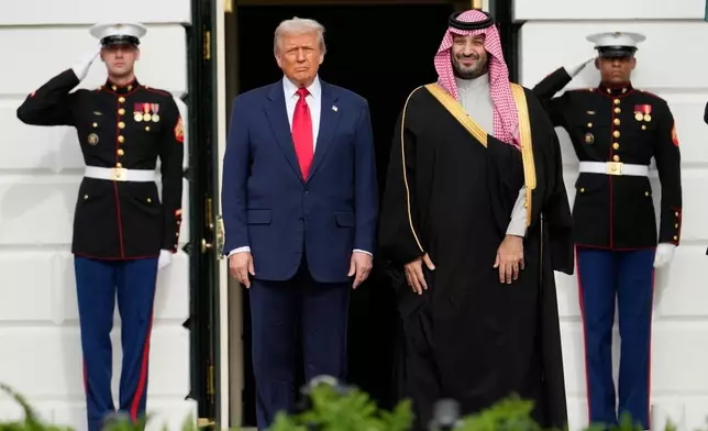 President Donald Trump stands with Saudi Arabia's Crown Prince Mohammed bin Salman on his visit to the White House, Tuesday, Nov. 18, 2025, in Washington. (AP Photo/Mark Schiefelbein)