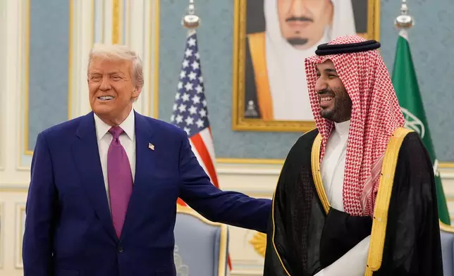 FILE - President Donald Trump and Saudi Crown Prince Mohammed bin Salman gesture as they meet delegations at the Royal Palace in Riyadh, Saudi Arabia, May 13, 2025. (AP Photo/Alex Brandon, File)