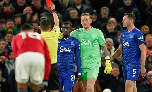Everton's Idrissa Gueye, third right, gets a red card from referee Tony Harrington during the English Premier League soccer match between Manchester United and Everton in Manchester, England, Monday, Nov. 24, 2025. (AP Photo/Dave Thompson)