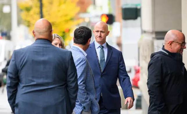 Former Alaska Airlines pilot Joseph Emerson, center, walks into U.S. District Court in Portland, Ore., Monday, Nov. 17, 2025. (AP Photo/Molly J. Smith)