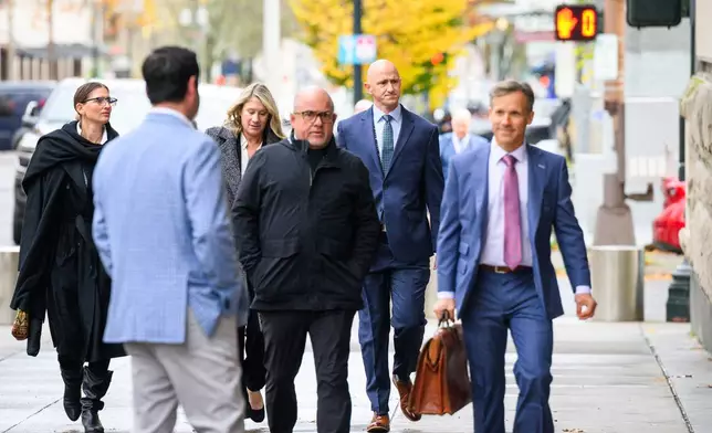 Former Alaska Airlines pilot Joseph Emerson, center, walks into U.S. District Court in Portland, Ore., Monday, Nov. 17, 2025. (AP Photo/Molly J. Smith)