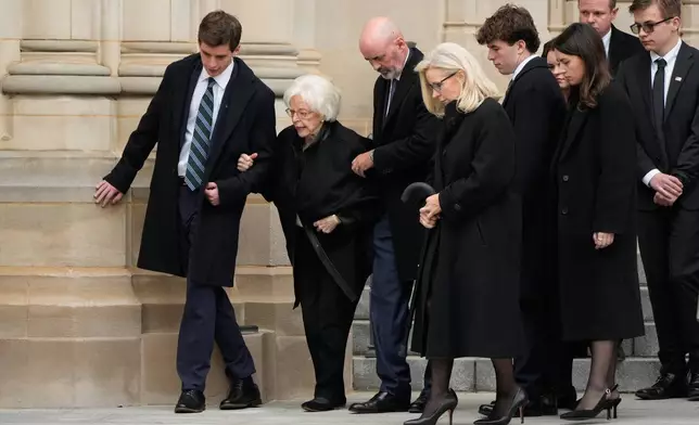 Wife of former Vice President Dick Cheney, Lynne Cheney second left, is escorted along with daughter, former Rep. Liz Cheney, R-Wyo., fourth left, and family after a memorial service for former Vice President Dick Cheney at the Washington National Cathedral, Thursday, Nov. 20, 2025, in Washington. (AP Photo/Mark Schiefelbein)