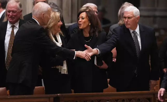 Former President Joe Biden shakes hands with former Vice President Mike Pence, with Jill Biden and former Vice President Kamala Harris, before the start of the funeral for former Vice President Dick Cheney at the Washington National Cathedral on Thursday, Nov. 20, 2025 in Washington. (AP Photo/Matt Rourke)