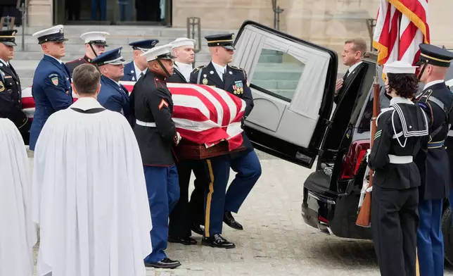 A joint services body bearer team carries the flag-draped casket of former Vice President Dick Cheney out of the Washington National Cathedral, Thursday, Nov. 20, 2025, in Washington. (AP Photo/Mark Schiefelbein)