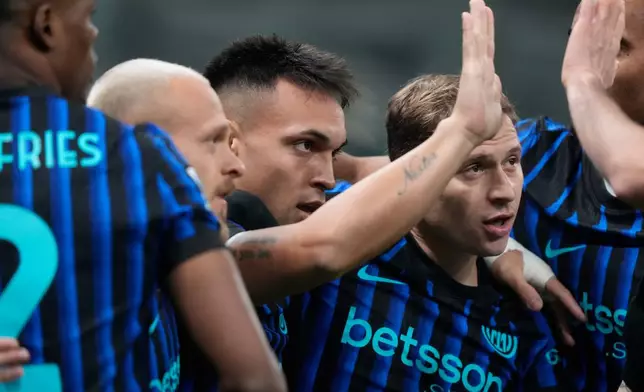 Inter Milan's Lautaro Martinez, center, celebrates after scoring his side's opening goal during a Serie A soccer match between Inter Milan and Lazio, in Milan, Italy, Sunday, Nov. 9, 2025. (AP Photo/Luca Bruno)