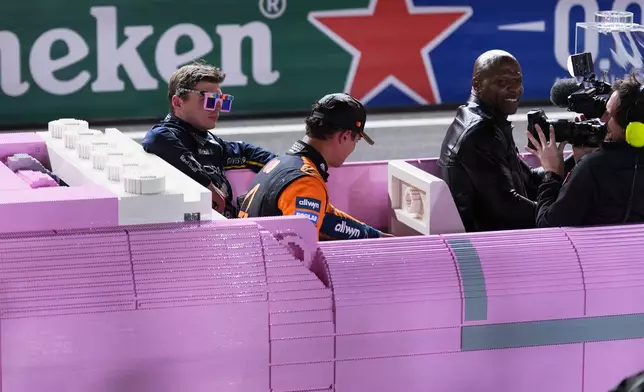 First place finisher Red Bull driver Max Verstappen of the Netherlands and second place finisher McLaren driver Lando Norris of Great Britain leave the track after the Formula One Las Vegas Grand Prix auto race, Saturday, Nov. 22, 2025 in Las Vegas. (AP Photo/Eric Gay)