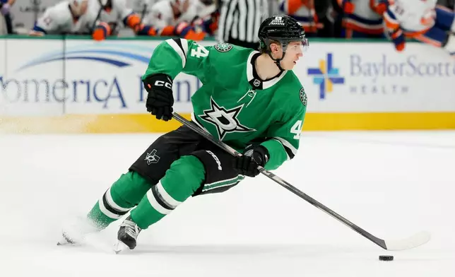 Dallas Stars defenseman Cody Ceci controls the puck during the second period of an NHL hockey game against the New York Islanders, Tuesday, Nov. 18, 2025, in Dallas. (AP Photo/Gareth Patterson)