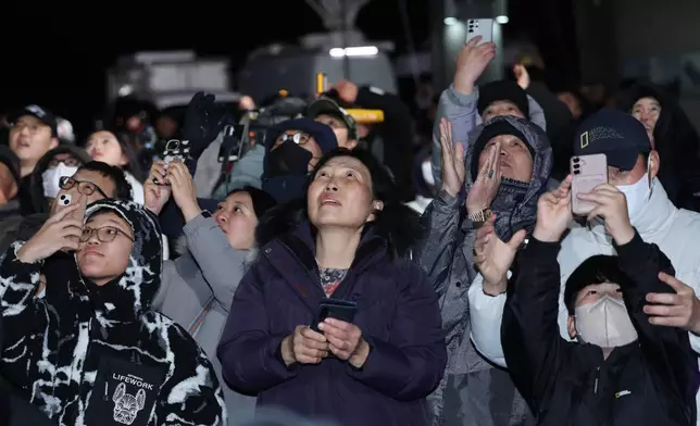 People watch the Nuri rocket taking off from the launch pad near the Naro Space Center in Goheung, South Korea, Thursday, Nov. 27, 2025. (Kim Hea-in/Yonhap via AP)