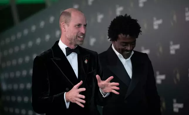 Britain's Prince William, left, and Brazilian singer Seu Jorge chat on the green carpet before the Earthshot Prize award ceremony at the Museum of Tomorrow in Rio de Janeiro, Wednesday, Nov. 5, 2025. (AP Photo/Bruna Prado)