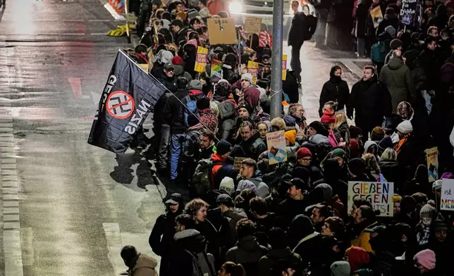 People demonstrate against the planned re-founding of the AfD youth organization in Giessen, Germany, early Saturday, Nov. 29, 2025. (AP Photo/Martin Meissner)
