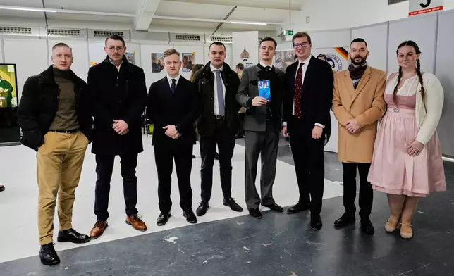 Highly ranked AfD youth delegates stand together at the beginning of the re-founding of the AfD youth organization in Giessen, Germany, early Saturday, Nov. 29, 2025. (AP Photo/Martin Meissner)
