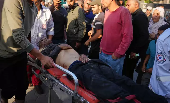 An injured Palestinian man is wheeled into Al-Aqsa Hospital in Deir al-Balah following Israeli strikes on the Gaza Strip, Saturday, Nov. 22, 2025. (AP Photo/Abdel Kareem Hana)