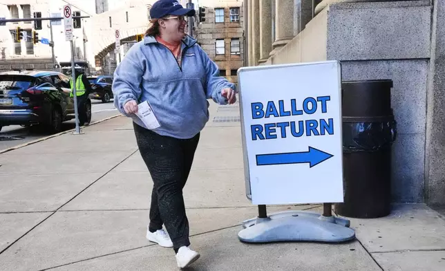 A voter drops off a mail-in ballot at the City-County Building in downtown Pittsburgh Tuesday, Nov. 4, 2025. (AP Photo/Gene J. Puskar)