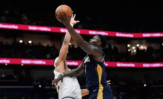New Orleans Pelicans forward Zion Williamson goes to the basket against Denver Nuggets forward Zeke Nnaji in the first half of an NBA basketball game, Wednesday, Nov. 19, 2025, in New Orleans. (AP Photo/Gerald Herbert)