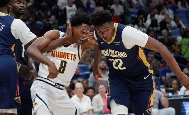 Denver Nuggets guard Peyton Watson (8) is fouled by New Orleans Pelicans center Derik Queen (22) in the first half of an NBA basketball game, Wednesday, Nov. 19, 2025, in New Orleans. (AP Photo/Gerald Herbert)
