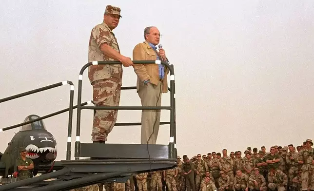 FILE - Secretary of Defense Dick Cheney, right, and Gen. Colin Powell, chairman of the Joint Chiefs of Staff, speak to members of the 354th Tactical Fighter Wing from Myrtle Beach, S.C. at their air base in Saudi Arabia, July 18, 1991. (AP Photo/Bob Daugherty, File)