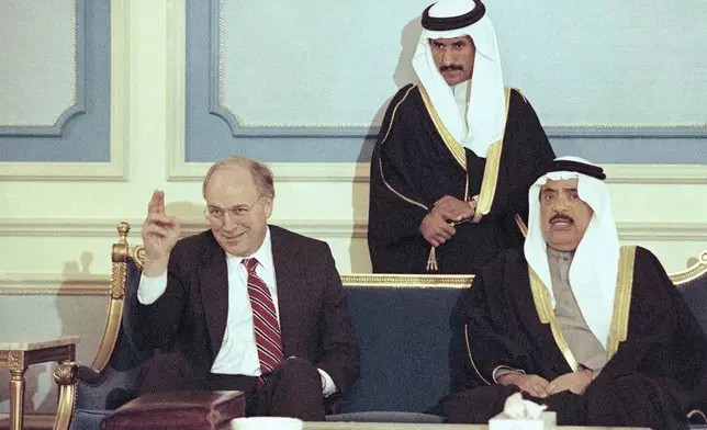 FILE - Secretary of Defense Dick Cheney waves during a reception at an airbase in Riyadh, central Saudi Arabia, Feb. 8, 1991 as he meets with Saudi Assistant Minister of Defense Utman Al Hamaide. Cheney and Chairman of the Joint Chiefs of Staff Colin Powell are in Saudi Arabia to assess the Gulf War. (AP Photo/John Gaps III, file)