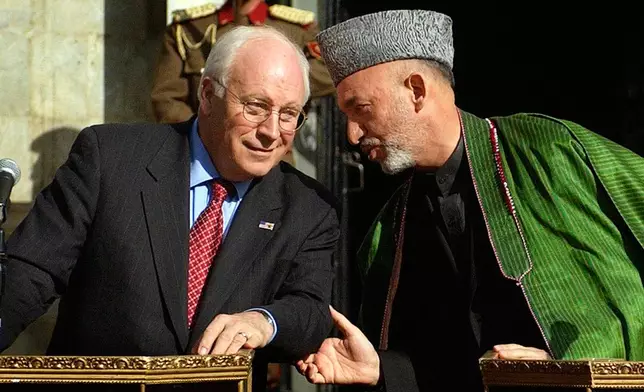 FILE - Afghan President Hamid Karzai, right, talks with U.S. Vice President Dick Cheney during a press conference at the presidential palace in Kabul, Afghanistan, on Tuesday, Dec. 7. 2004 after Karzai's inauguration. (AP Photo/Emilio Morenatti, file)