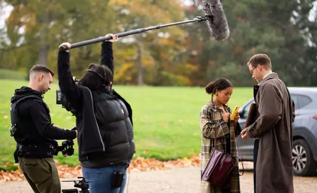 Antonia Thomas, second right, and and Josh Dylan, right appear during the filming of the Agatha Christie series "Tommy &amp; Tuppence" in Beaconsfield, England on Wednesday, Oct. 29, 2025. (Photo by Scott A Garfitt/Invision/AP)