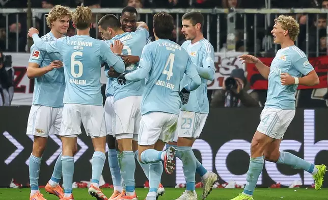 Union's scorer Rani Khedira, third left, and his teammates celebrate the opening goal during the German Bundesliga Soccer match between 1. FC St. Pauli and 1. FC Union Berlin in Hamburg, Germany, Sunday, Nov. 23, 2025. (Christian Charisius/dpa via AP)