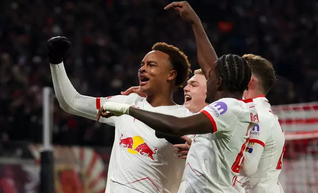 Leipzig's scorer Assan Ouedraogo, left, and his teammates celebrate the opening goal during the German Bundesliga Soccer match between RB Leipzig and Werder Bremen in Leipzig, Germany, Sunday, Nov. 23, 2025. (Jan Woitas/dpa via AP)