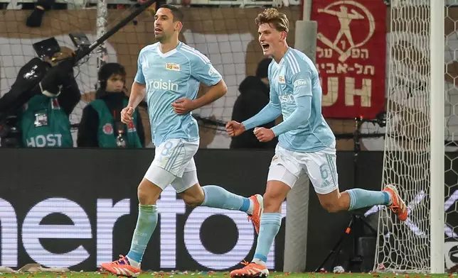 Union's Rani Khedira, left, after scoring the opening goal during the German Bundesliga Soccer match between 1. FC St. Pauli and 1. FC Union Berlin in Hamburg, Germany, Sunday, Nov. 23, 2025. (Christian Charisius/dpa via AP)