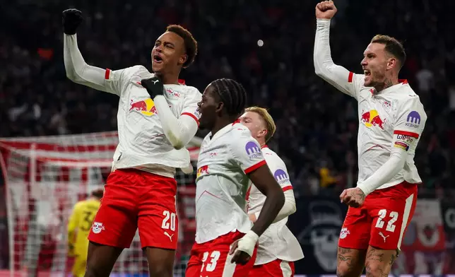 Leipzig's scorer Assan Ouedraogo, left, and and his teammates celebrate the opening goal during the German Bundesliga Soccer match between RB Leipzig and Werder Bremen in Leipzig, Germany, Sunday, Nov. 23, 2025. (Jan Woitas/dpa via AP)