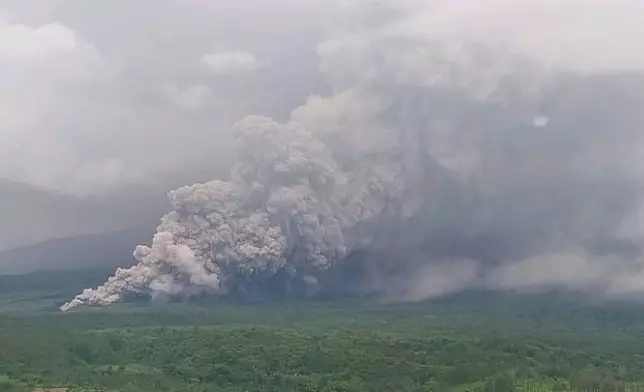 In this photo released by the Geological Agency (Badan Geologi) of Indonesia's Ministry of Energy and Mineral Resources, Mount Semeru releases volcanic materials during an eruption in Lumajang, East Java, Indonesia, Wednesday, Nov. 19, 2025. (Badan Geologi via AP)