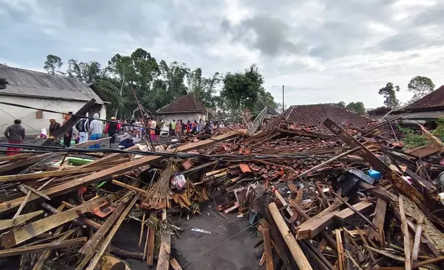 People inspect the damage caused by the eruption of Mount Semeru in Lumajang, East Java, Indonesia, Thursday, Nov. 20, 2025. (AP Photo/Wawan Sugiarto)