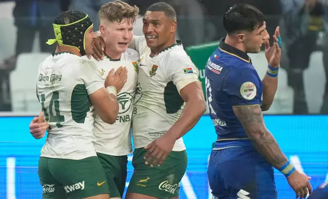 South Africa's Ethan Hooker, second left, celebrates after scoring a try during the rugby union Nations Series match between Italy and South Africa, in Turin, Italy, Saturday, Nov. 15, 2025. (AP Photo/Luca Bruno)