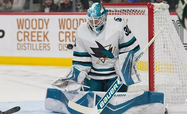 San Jose Sharks goaltender Yaroslav Askarov (30) blocks a shot during the first period of an NHL hockey game against the Minnesota Wild, Tuesday, Nov. 11, 2025, in St. Paul, Minn. (AP Photo/Abbie Parr)