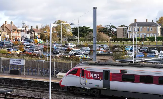 A train is stopped at a railway station after a mass stabbing on a London-bound train in Huntingdon, England, Sunday, Nov. 2, 2025.(AP Photo/Kirsty Wigglesworth)