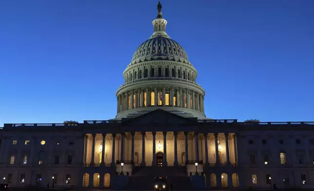 The U.S. Capitol is seen on a sunset a day before the House prepares to vote on a bill to reopen the government at the Capitol in Washington, Tuesday, Nov. 11, 2025. (AP Photo/Jose Luis Magana)