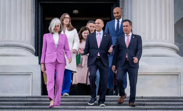 House Minority Leader Hakeem Jeffries, D-N.Y., center, flanked by Rep. Katherine Clark, D-Mass., House minority whip, and Rep. Pete Aguilar, D-Calif., lead fellow Democrats to speak on the health care funding fight on the steps of the House before votes to end the government shutdown, at the Capitol in Washington, Wednesday, Nov. 12, 2025. (AP Photo/J. Scott Applewhite)