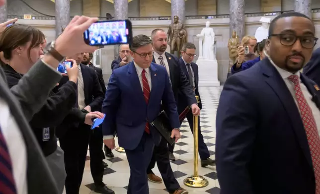 Speaker of the House Mike Johnson, R-La., center, walks to the House chamber at the U.S. Capitol, Wednesday, Nov. 12, 2025, in Washington. (AP Photo/Rod Lamkey, Jr.)