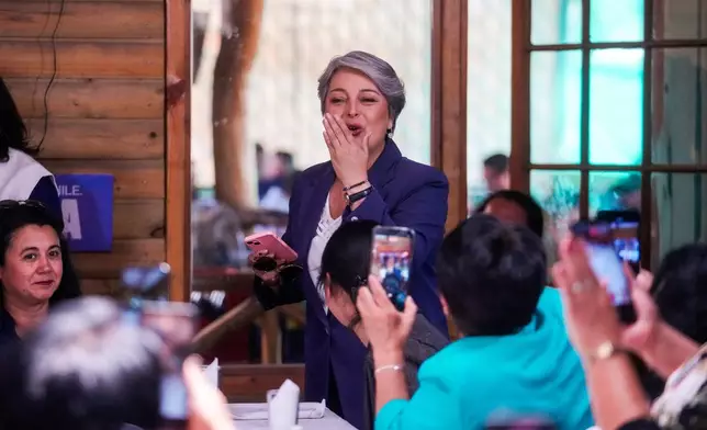 Presidential candidate Jeannette Jara of the Unidad por Chile coalition arrives at a meeting with local leaders in the La Pintana neighborhood of Santiago, Chile, Monday, Nov. 17, 2025. (AP Photo/Esteban Felix)