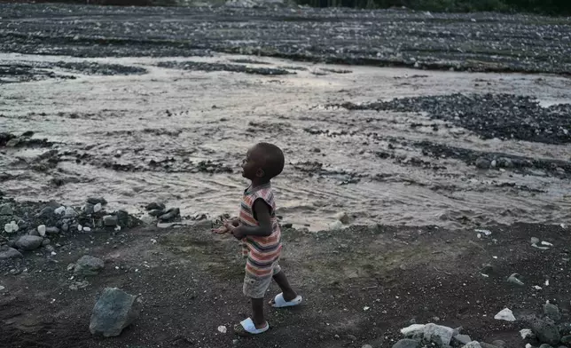 A child walks on the banks of La Digue River in the aftermath of Hurricane Melissa in Petit-Goave, Haiti, Thursday, Nov. 6, 2025. (AP Photo/Odelyn Joseph)