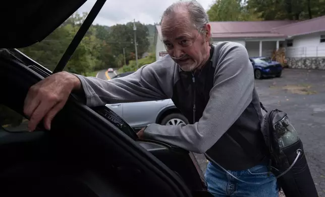 Former coal miner and black lung disease patient Roger James pauses to catch his breath after walking across the parking lot at the Maynor Freewill Baptist Church, Sept. 24, 2025, in Beckley, W.Va. (AP Photo/Carolyn Kaster)
