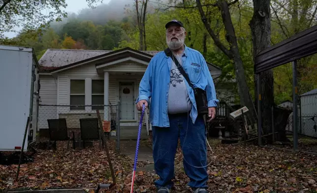 Randy Lawrence, president of the Kanawha County Black Lung Association, stands outside his home wearing supplemental oxygen for black lung disease near Cabin Creek, W.Va., Oct. 13, 2025. (AP Photo/Carolyn Kaster)