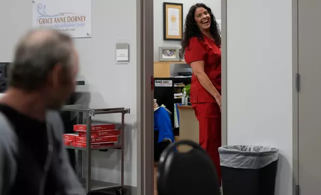 Roger James, a former coal miner and black lung patient, left, looks at Lisa Emery, director of the New River Health Association Black Lung Clinic, at the clinic on Sept. 24, 2025, in Oak Hill, W.Va. (AP Photo/Carolyn Kaster)