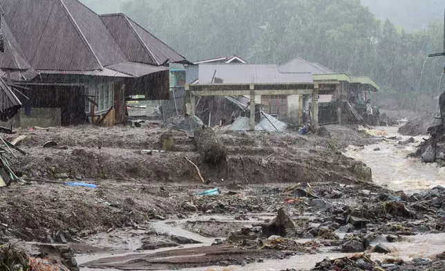 Houses are seen damaged after a flood hit in Malalak, West Sumatra, Indonesia, Thursday, Nov. 27, 2025. (AP Photo/Ade Yuandha)