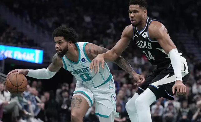 Charlotte Hornets' Miles Bridges tries to get past Milwaukee Bucks' Giannis Antetokounmpo during the first half of an NBA basketball game Friday, Nov. 14, 2025, in Milwaukee. (AP Photo/Morry Gash)