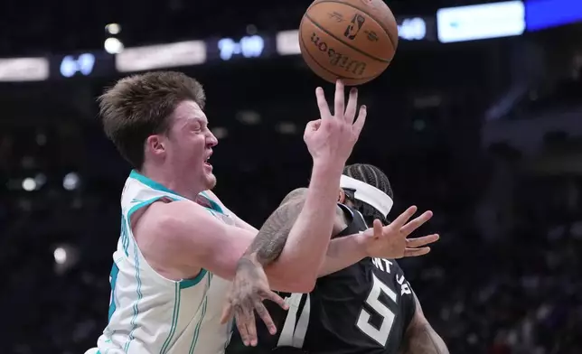 Charlotte Hornets' Kon Knueppel is fouled by Milwaukee Bucks' Gary Trent Jr. during the first half of an NBA basketball game Friday, Nov. 14, 2025, in Milwaukee. (AP Photo/Morry Gash)