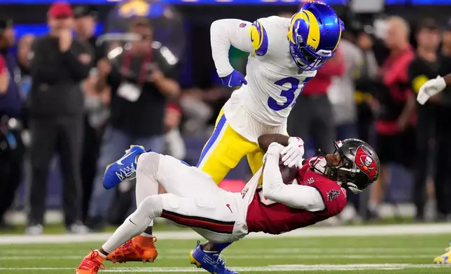 Los Angeles Rams cornerback Darious Williams (31) defends against Tampa Bay Buccaneers wide receiver Tez Johnson, bottom, during the first half of an NFL football game Sunday, Nov. 23, 2025, in Inglewood, Calif. (AP Photo/Mark J. Terrill)